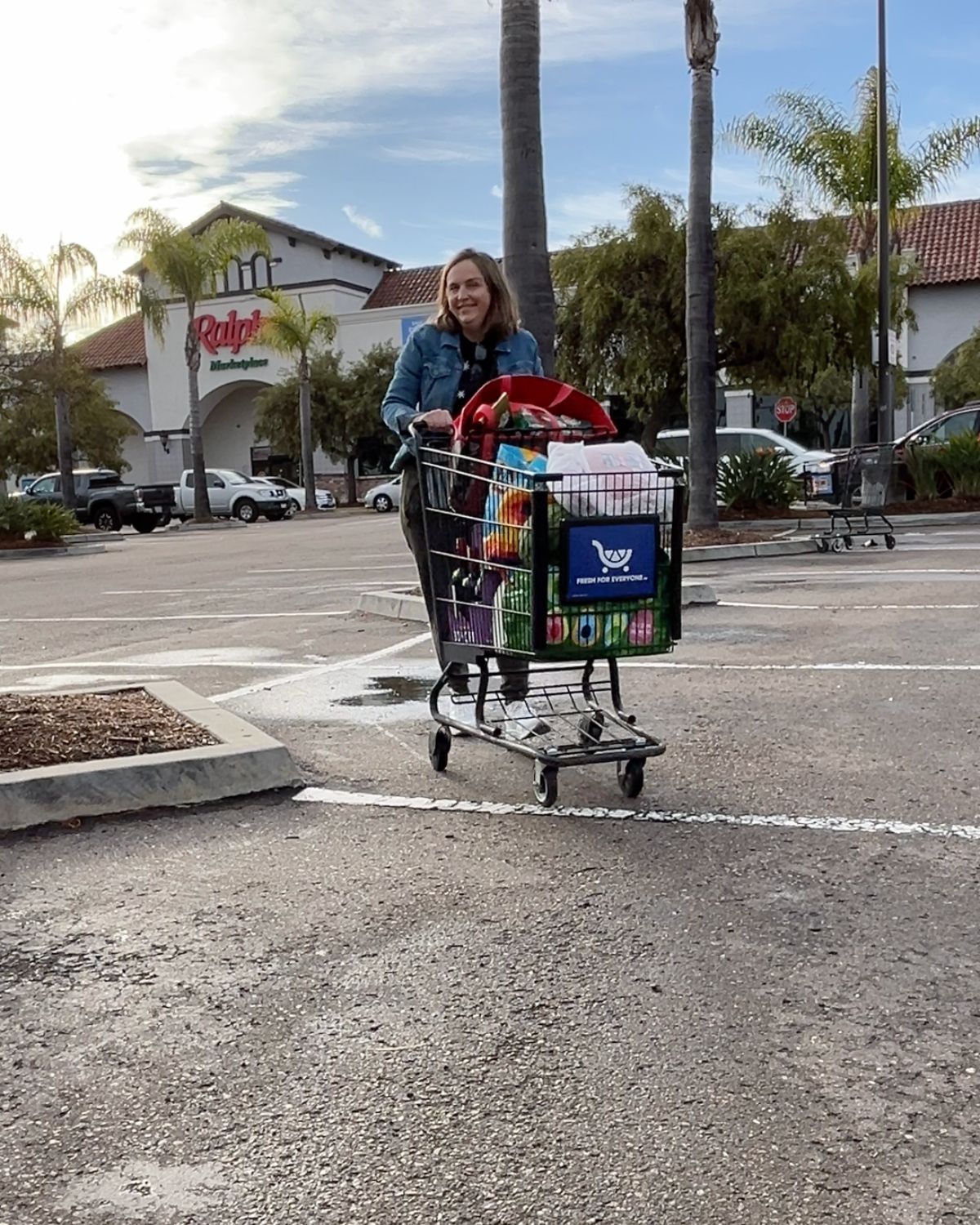 jessica pushing grocery cart in ralphs parking lot.