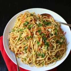 large white bowl of noodle stir fry.