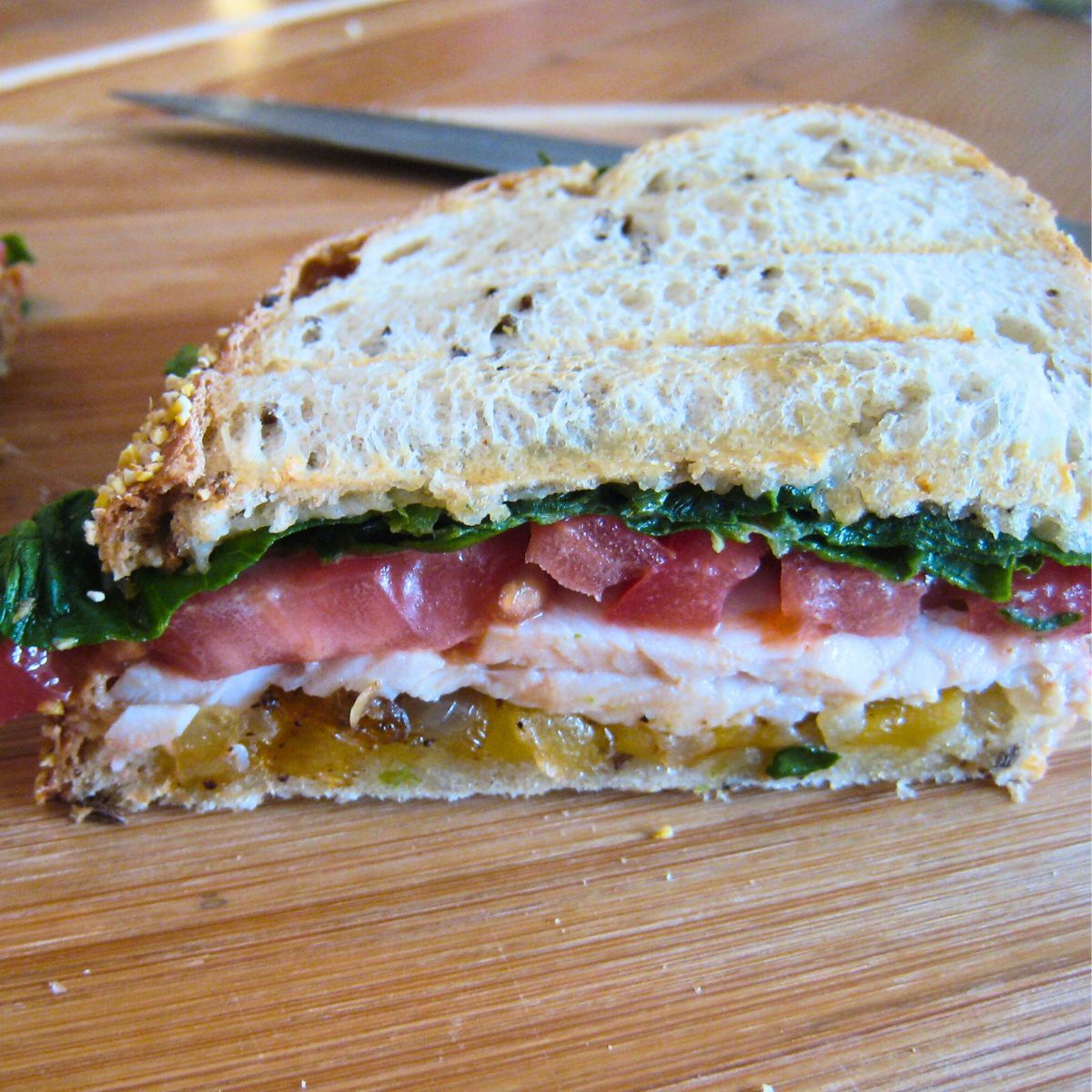 side cut view of turkey cheddar melt on cutting board.