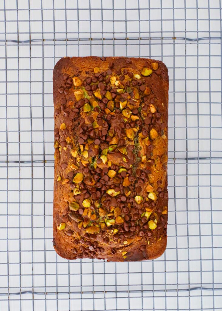 the baked loaf cake cooling on a rack.