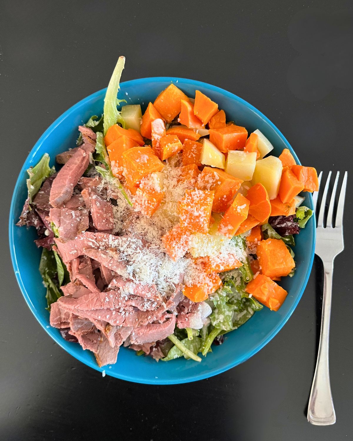 salad with roast beef and sweet potatoes, topped with parmesan.