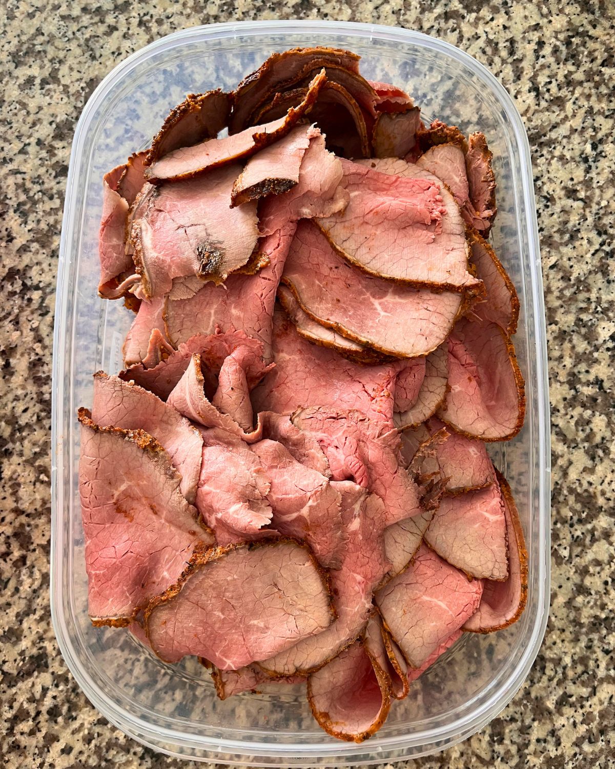 sliced roast beef in large meal prep container.