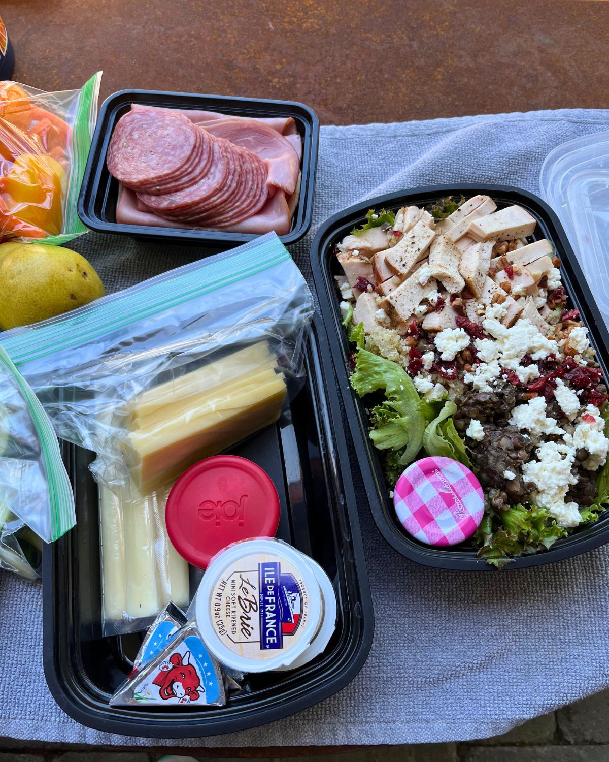 meal prepped boxes with snacks and salads.