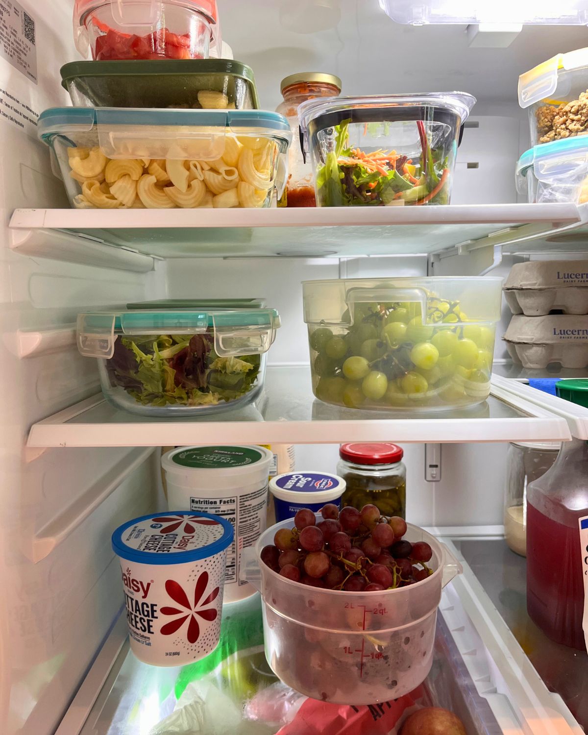 prepped food on shelves in open refrigerator.
